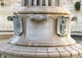 Closeup view of the base of The Fountain of Harmony in front of Castle Charles V, Lecce